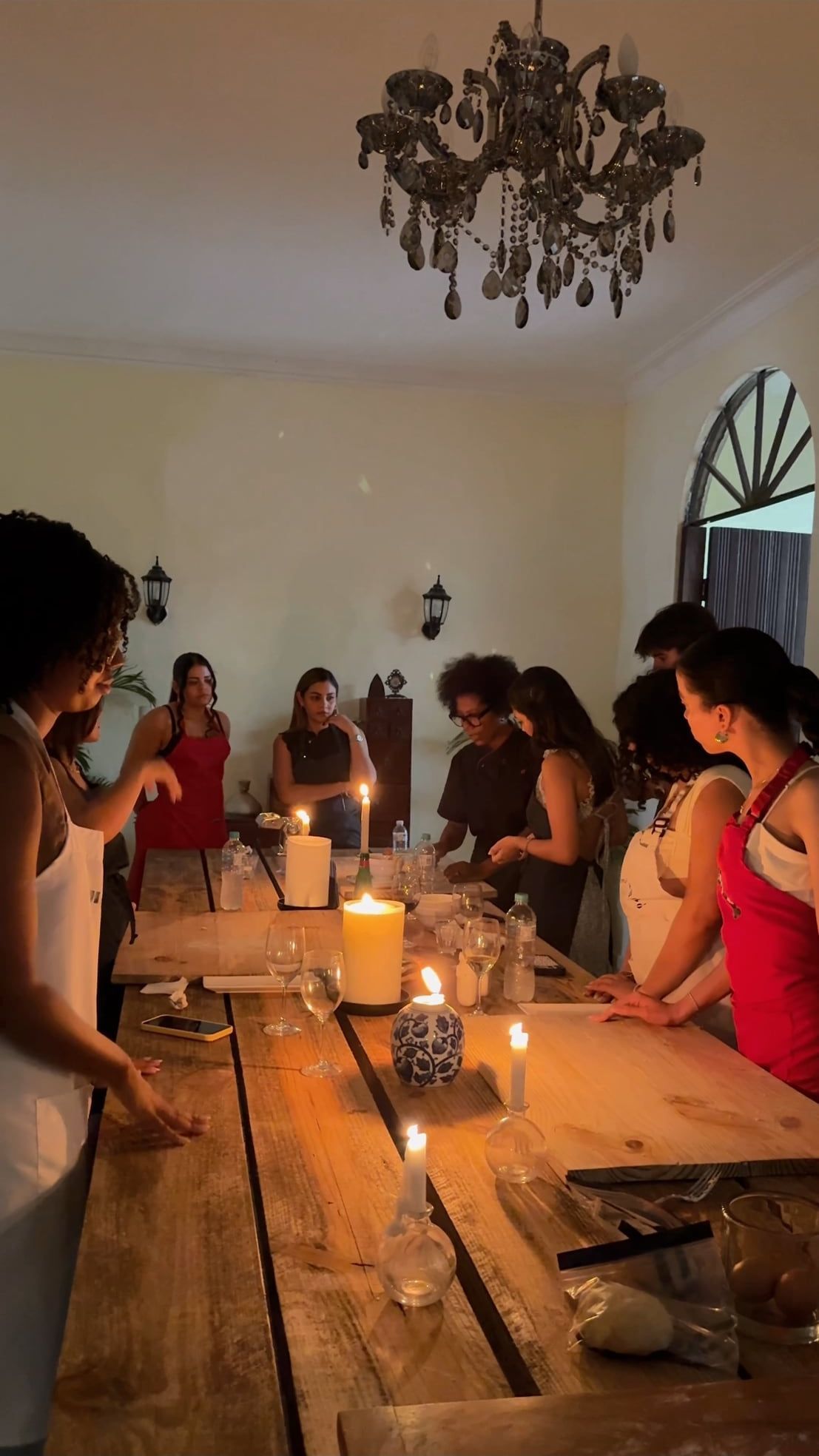 Un grupo alrededor de la mesa larga, a la luz de las velas
